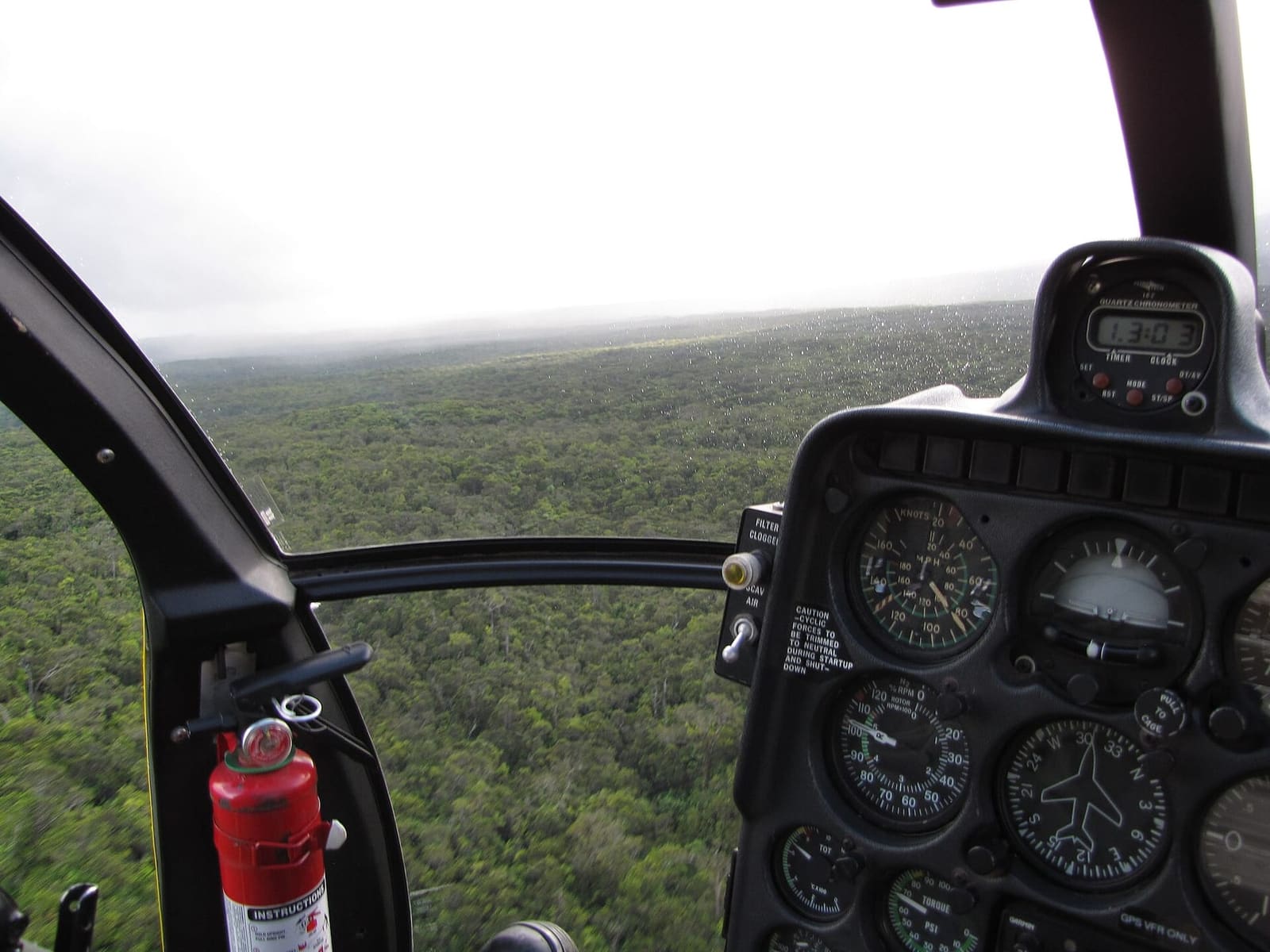 Aerial view of East Maui through a helicopter windscreen with the instrument panel in the foreground